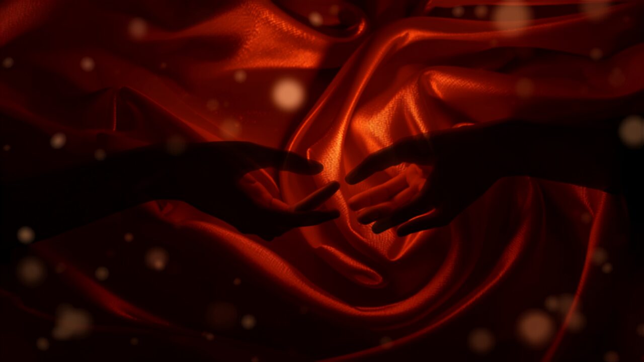 Silhouetted hands reaching toward each other through flowing amber silk, symbolizing desire discrepancy and reconnection in relationships