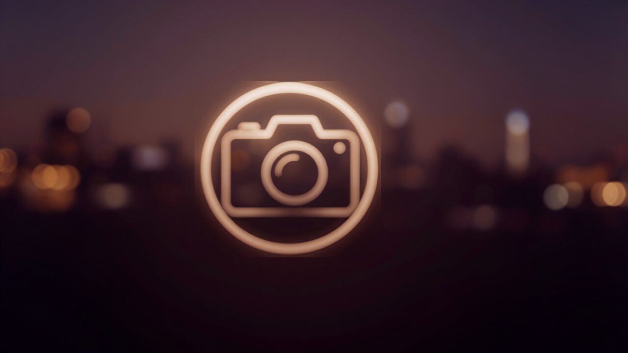 Abstract camera icon glowing over a blurred city skyline at dusk, symbolizing popular US content creator branding